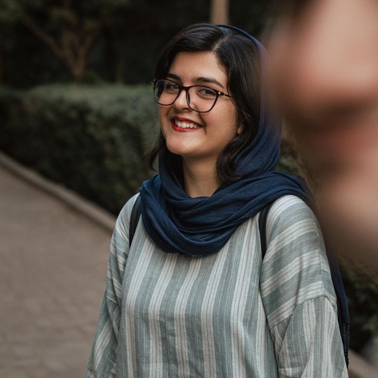 Kaveri Mehta, Lead Design Curator at Stone Glass Studio, reviewing corporate floral arrangements